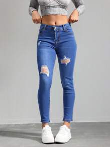 Jeans ajustados de cintura alta en azul con desgarros, tela suave y elástica, ideal para estilos casuales y versátiles