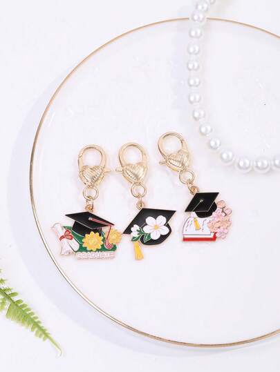 قلادة من المعدن بشكل طقم تخرج مزخرفة بأزهار الكرز والآفول لموسم التخرج، لنساء والفتيات لتعليقها على الحقائب، حقائب الظهر، من الهدايا DIY