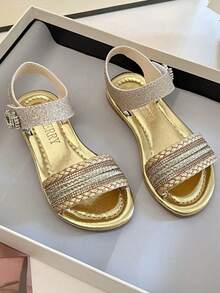 A Pair Of Summer Bestselling Children's Non-Slip Sandals. The Upper Is Mainly Gold, With Braided Ribbon Design, With Shiny Decorative Bands, Ankle Buckles And Fine Metal Decoration - Gold - View 7