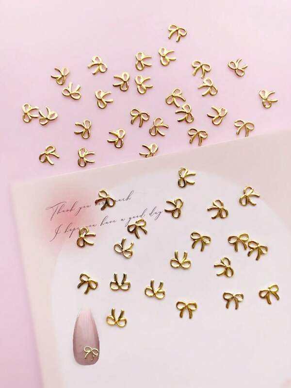 100 قطعة من الحلي المعدنية الصغيرة بتصميم الفيونكة لتزيين الأظافر، منتجات أظافر بفيونكة مفرغة، أنماط شائعة في اليابان وكوريا الجنوبية، مناسبة لمستلزمات صالونات الأظافر الصغيرة