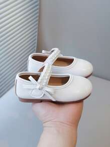 Nuevos zapatos planos elegantes para niñas con diseño de lazos de perlas, calzado versátil para uso diario y casual, de fácil puesta y livianos