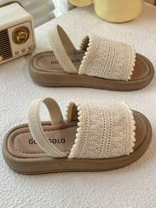 A Pair Of Children's Sandals. The Upper Is Made Of Cream-Colored Crochet Material, And The Edge Is Decorated With Pompoms. The Design Is Exquisite And Cute, And The Hook And Loop Belt Of The Same Color Is Matched. The Overall Style Is Sweet And Casual, Suitable For 3-12 Year Old Girls In The Summer Daily Travel, Walking And Other Occasions To Wear, Can Show The Pure And Lovely Elegant.