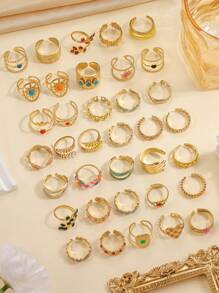 16 piezas de anillos de acero inoxidable de color amarillo dorado con apertura ajustable y decoración de color, apropiados para decoración diaria o regalo. El patrón y el color se enviarán de forma aleatoria.