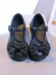 Zapatos elegantes negros para niñas: El lacito añade un Charm femenino