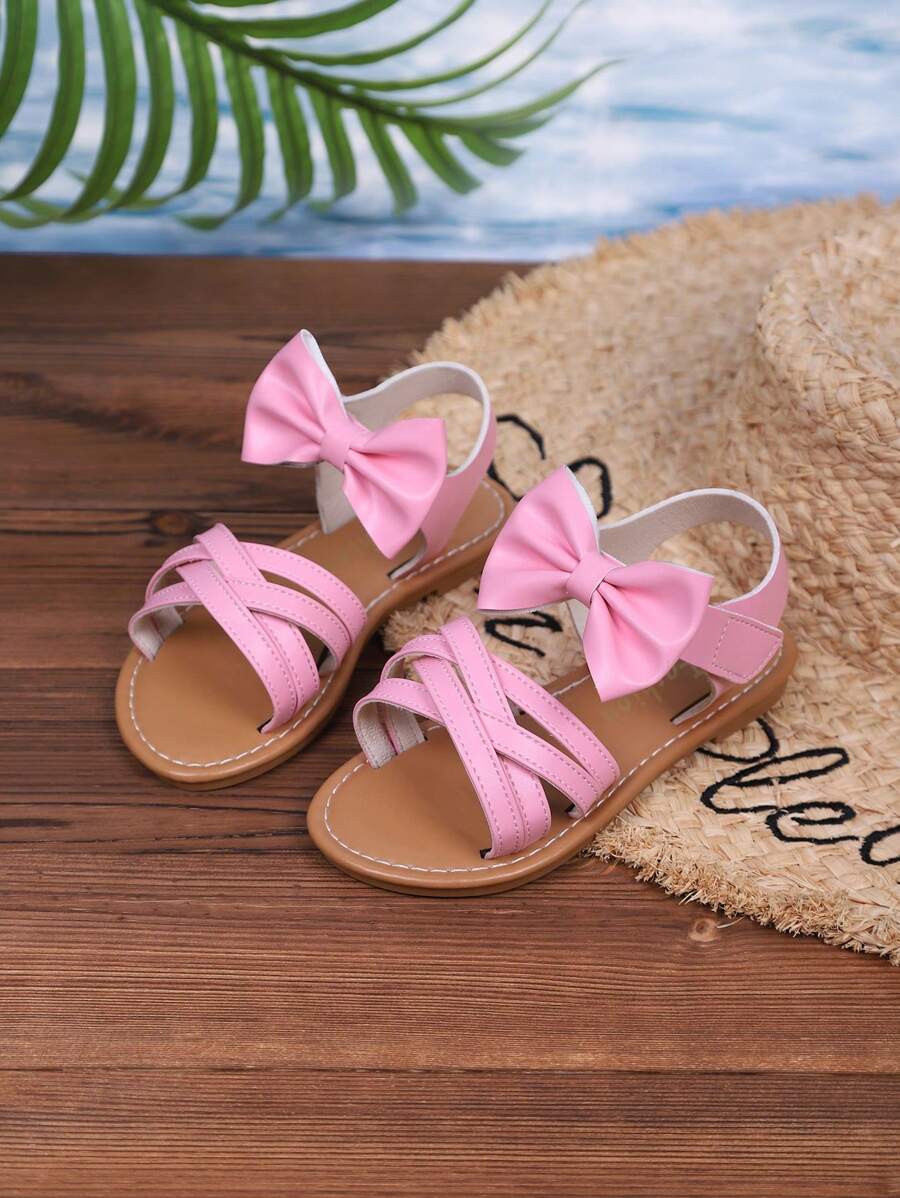 Sandalias casuales nuevas de verano 2025 para niños, diseño de lazo rosa, apariencia de moda, versátiles, sandalias casuales populares
