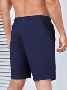 Shorts deportivos tipo novio con diseño gráfico de letras Corelite para hombres, shorts de gimnasia, shorts jogger con bolsillo con cremallera y cordón en la cintura, para entrenamiento, correr, gimnasio en verano