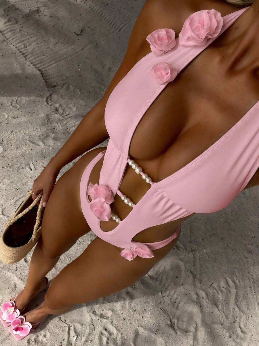 Bộ đồ bơi liền thân nữ họa tiết hoa 3D và ngọc trai giả. Được làm từ chất liệu co giãn cao, thân thiện với da, mang lại sự thoải mái và thoáng khí. Thiết kế cổ yếm chữ V sâu tôn dáng, được trang trí bằng hoa hồng 3D và viền ngọc trai giả. Các đường cắt xẻ bên hông gợi cảm và bắt mắt. Lý tưởng cho các kỳ nghỉ và những chuyến đi biển, một lựa chọn hàng đầu để tạo nên phong cách nghỉ dưỡng. Màu hồng mùa hè. - Hồng - Xem 1