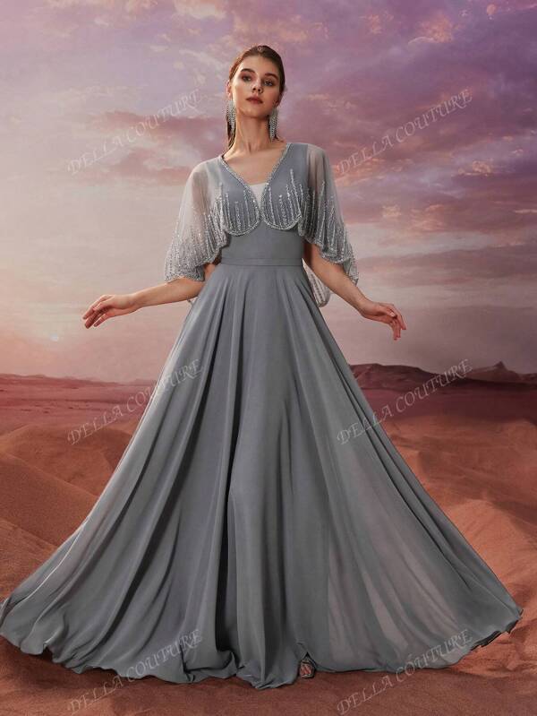 DELLA COUTURE Elegant Slim Gray V-Neck Long Cape Sleeve Women's Chiffon Evening Dress Features A Large Hemline With A Flowing Cape And Is Beautifully Embellished With SequinsGorgeous Floor-Length Gowns For Evening Parties, Gatherings, And Cocktail Receptions!