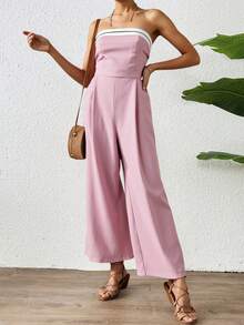 Mono largo de hombros descubiertos para mujer, de corte recto y con detalles de rayas decorativas en el escote. Confeccionado en tejido ligero con una caída espectacular, es perfecto para eventos de día o de noche y combina a la perfección con sandalias, tacones o accesorios elegantes. Esta versátil prenda estiliza la figura y ofrece un toque moderno y sofisticado, diseñado para quienes buscan comodidad y estilo. - Rosa - Ver 1