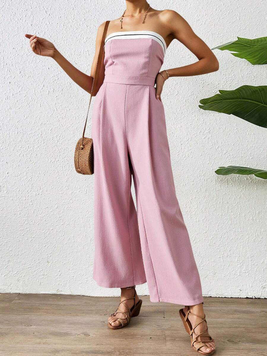 Mono largo de hombros descubiertos para mujer, de corte recto y con detalles de rayas decorativas en el escote. Confeccionado en tejido ligero con una caída espectacular, es perfecto para eventos de día o de noche y combina a la perfección con sandalias, tacones o accesorios elegantes. Esta versátil prenda estiliza la figura y ofrece un toque moderno y sofisticado, diseñado para quienes buscan comodidad y estilo. - Rosa - Ver 1