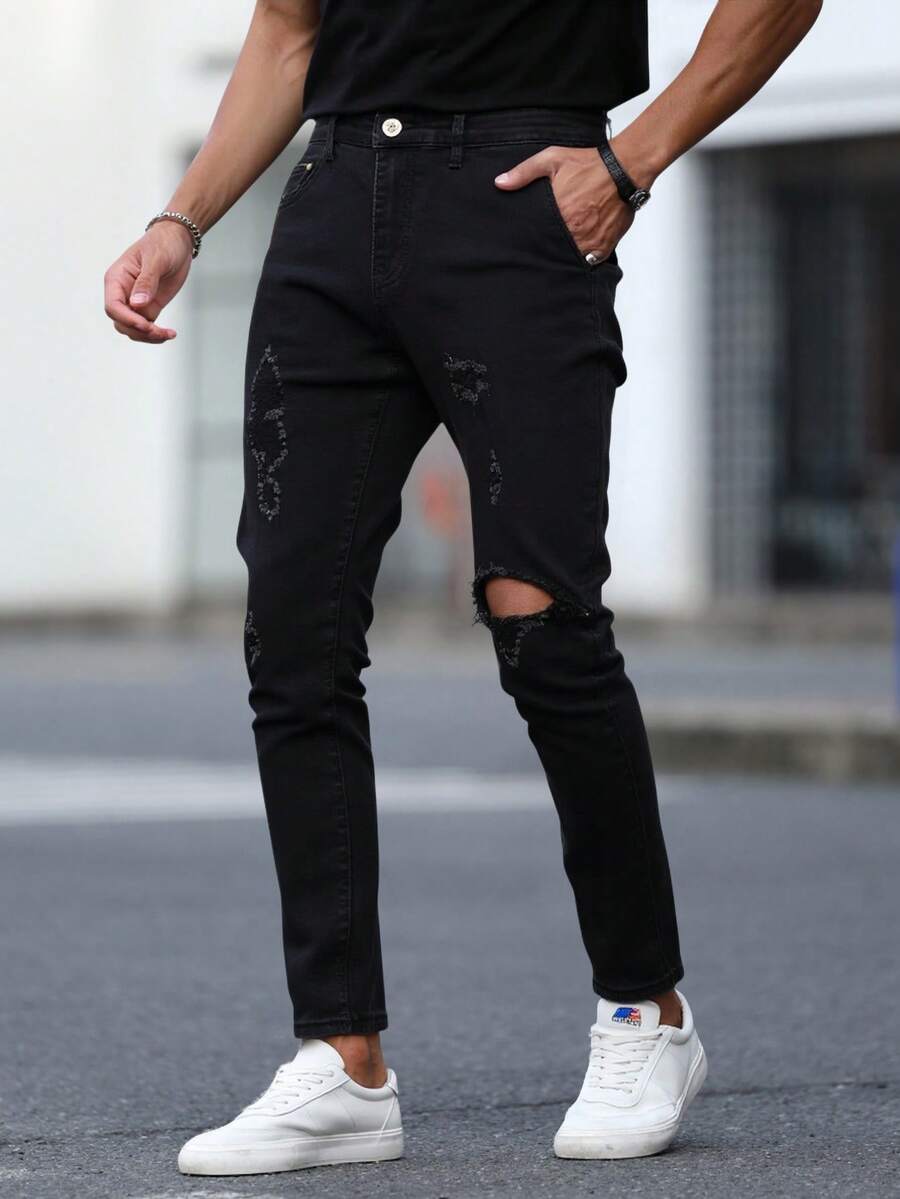 Pantalones jeans ajustados para hombres en denim negro con desgarros, tela suave y elástica, ideales para estilos casuales y modernos - Negro - Ver 1