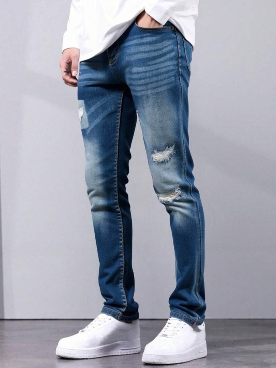 Pantalones jeans ajustados para hombres en denim azul oscuro con efecto de desgaste y rotura, tela suave y elástica, ideales para estilos casuales y modernos - Azul lavado oscuro - Ver 1