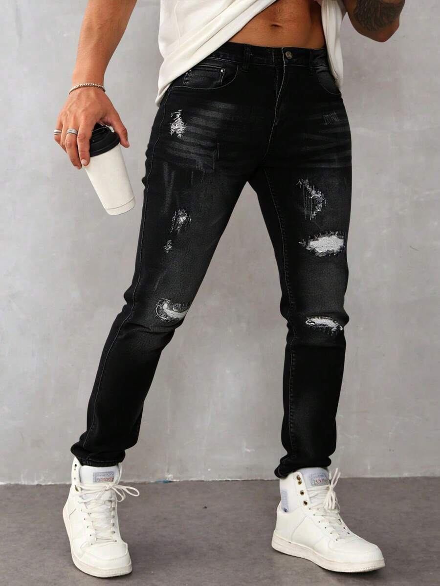 Pantalones jeans ajustados para hombres en denim negro con efecto de desgaste y rotura, tela suave y elástica, ideales para estilos casuales y modernos - Negro - Ver 1