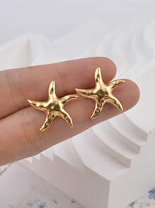 1 paire de boucles d'oreilles style rétro et simple en forme d'étoile de mer, dans un style de vacances européen et américain. Boucles d'oreilles en étoile polyvalentes et . Conviennent pour les femmes allant à la plage et s'assortissant