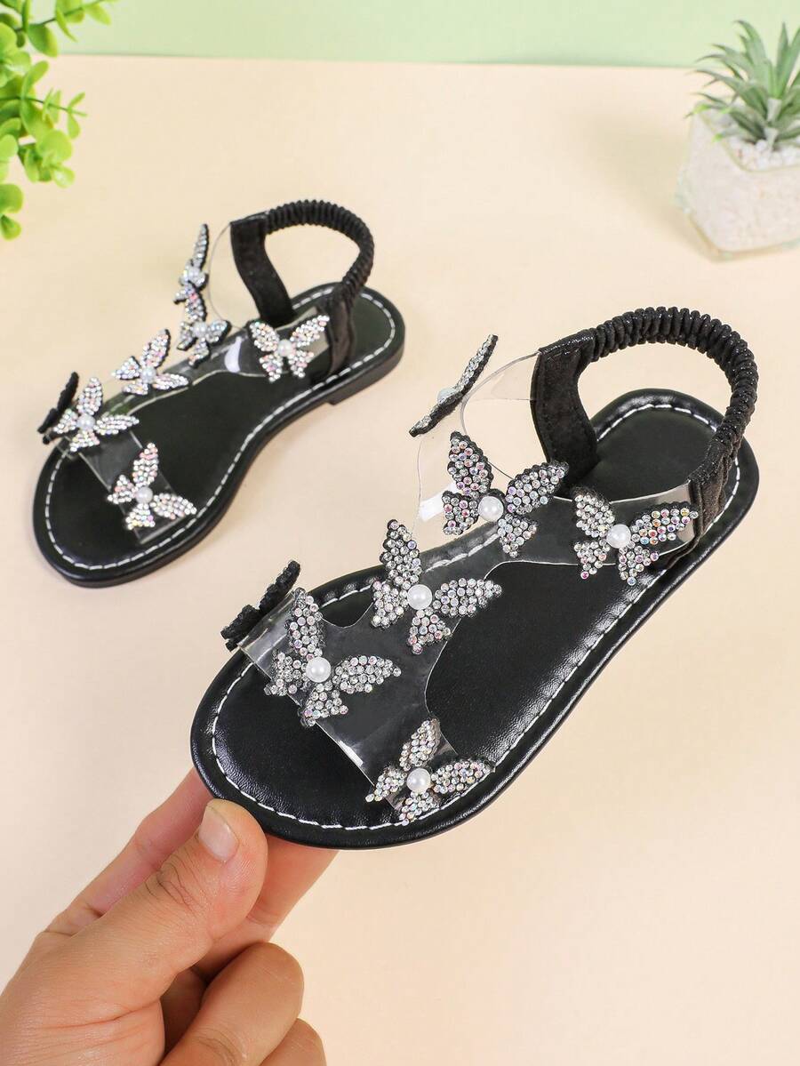 1 Paar Modische Sandalen für Mädchen in Große Größen, Schwarz, mit Glitzer-Strass-Schmetterling-Dekor, elastischem Knöchelriemen, runder Zehenpartie, flache rutschfeste hübsche römische Sandalen, geeignet für Mädchen von 3-15 Jahren für Alltag, Party, Reise, Sommer - Schwarz - Übersicht 1