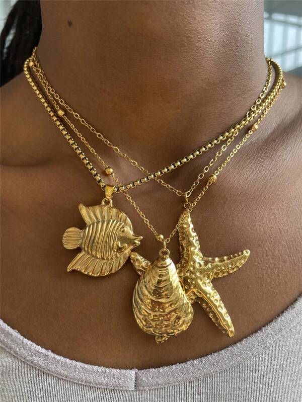 Collar con colgante diseño minimalista de elementos marinos de acero inoxidable con pez, estrella de mar y concha para mujer