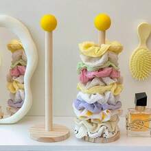 简约时尚的木质发夹收纳架，适用于卧室梳妆台、化妆桌等多种场合。主体采用天然木色，无多余图案，保留木材的天然纹理。圆柱形框架，分层设计，方便取用。表面光滑无毛刺，圆角设计不会损伤发饰。集收纳和展示功能于一体，可整齐收纳发圈、发带、发夹等发饰。 - 彩色 - 查看 9