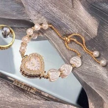 1 pièce Montre à quartz mode mignonne pour femmes avec boîtier en alliage décoré de perles en forme de cœur bicolore et cadran chiffres arabes