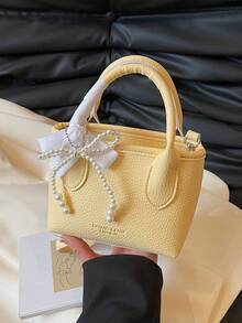 极简浅黄色女士手提包，奢华金箔字母装饰单肩包，时尚蝴蝶结吊坠可调节肩带斜挎水桶包，大学生日常旅行轻便收纳包，拉链多功能通勤包，耐用PU材质手提包，适合送礼、购物、约会、商务旅行、度假等场合。 - 黃色 - 查看 7