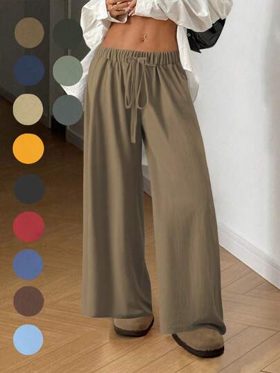 飘逸阔腿裤：轻盈梭织面料搭配弹力抽绳腰带，修身显瘦，是通勤、购物和居家休闲的必备单品。新款春秋季女士休闲裤，适合约会、学生和日常出行。百搭风格，休闲、海滩等各种场合皆宜。抽绳腰带设计，适合外出和居家穿着。