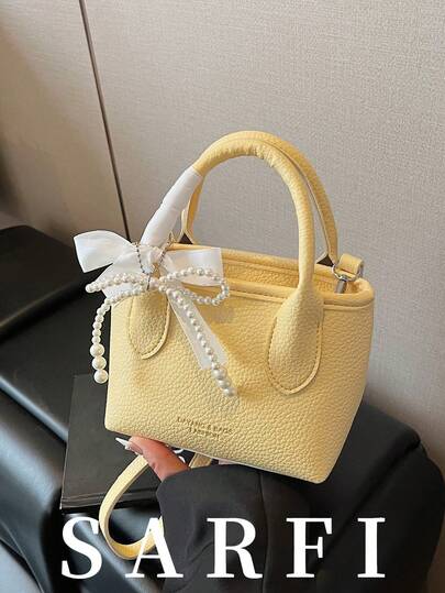 Minimalist Light Yellow Women's Handbag, Luxury Gold Foil Letter Decor Shoulder Bag, Fashion Bow Pendant Adjustable Strap Crossbody Bucket Bag, College Student Daily Travel Lightweight Storage Tote, Zipper Closure Multi-Functional Commuter Bag, Durable PU Material Handbag, Suitable For Gifting Friends, Shopping, Dating, Business Travel, Vacation And Other Occasions.