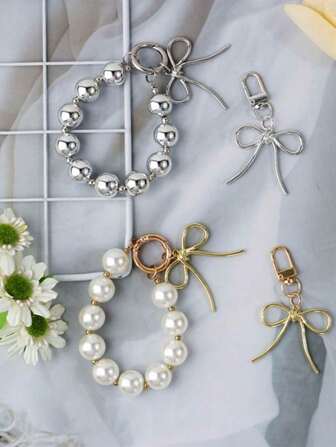 珍珠蝴蝶结钥匙扣、精美包包挂件钥匙扣、串珠钥匙圈、手机挂件、轻奢版树脂合金珍珠挂件、手机链、汽车钥匙扣、包包装饰、腕带，时尚百搭，适合多种场合
