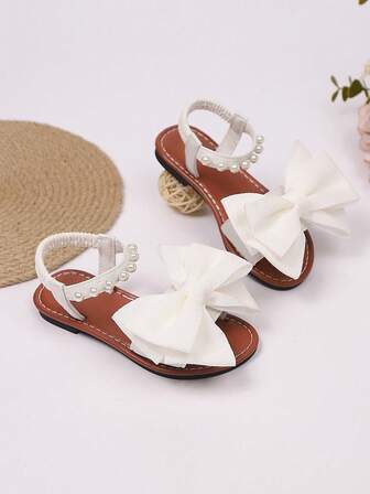 1 双时尚百搭粉色女童珍珠和水钻蝴蝶结可爱平底凉鞋，圆头，适合春秋季休闲、舞蹈、户外穿着，闪光装饰包头公主鞋