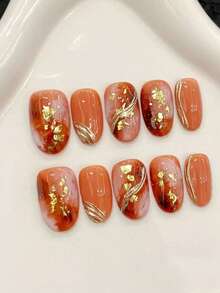 一套10片椭圆形日本金箔全覆盖手工可穿戴美甲套装，采用独特工艺，展现大胆时尚。适合派对、舞会和日常佩戴。附赠美甲工具套装，是送给女士和女孩的绝佳礼物。按压式美甲用品