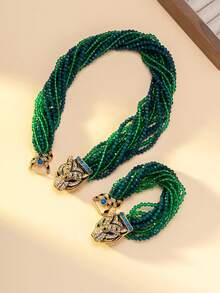 女士项链和手链套装，包含一条项链和一条手链，饰有渐变绿蓝珠子，并以镶嵌蓝色宝石和钻石的精致虎头扣点缀。独特的设计融合了粗犷与迷人的元素，适合搭配极简主义或前卫风格的服装，是派对造型的完美配饰，也是整体造型的焦点。 - 彩色 - 查看 12