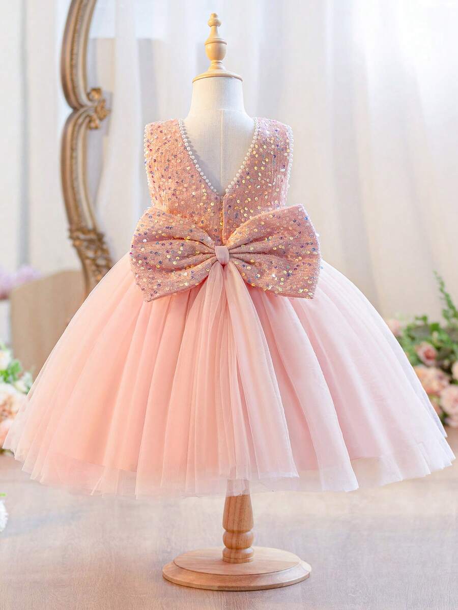 Váy đính sequin hồng cao cấp cho bé gái, trang trí nơ lớn, phù hợp cho tiệc sinh nhật, dẫn chương trình, biểu diễn sân khấu, thi đọc thơ và các dịp quan trọng khác. Mặc lên vừa nổi bật vừa thanh lịch. - Hồng - Xem 1