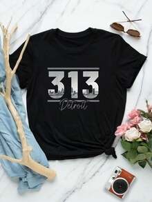Camiseta de mujer con el horizonte de Detroit | Camiseta con código de área de Michigan | Camiseta gráfica de manga corta para hombre y mujer | Top informal y cómodo para ropa urbana | Regalo de recuerdo | Camiseta de moda para mujer - Negro - Ver 1