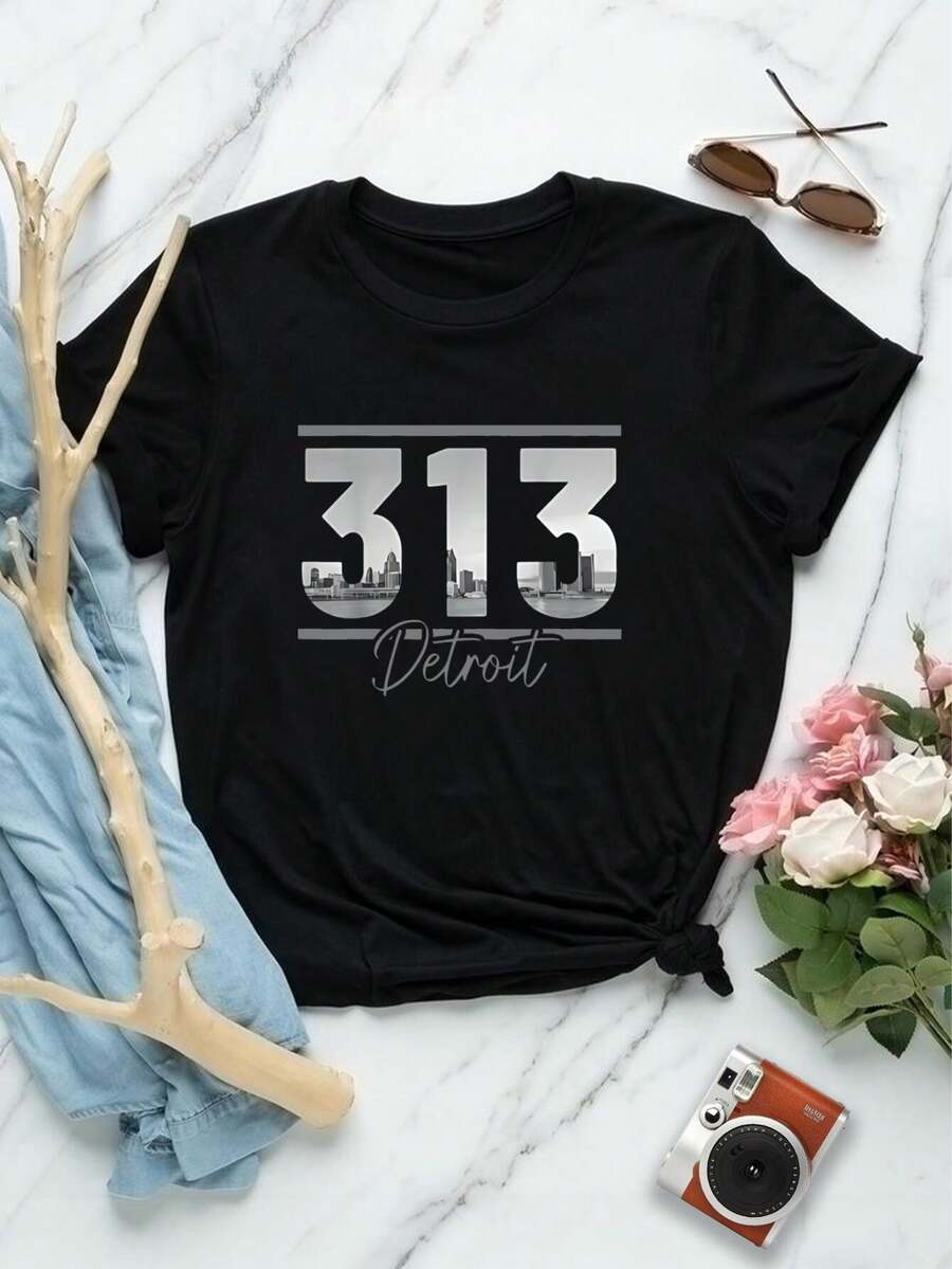 Camiseta de mujer con el horizonte de Detroit | Camiseta con código de área de Michigan | Camiseta gráfica de manga corta para hombre y mujer | Top informal y cómodo para ropa urbana | Regalo de recuerdo | Camiseta de moda para mujer - Negro - Ver 1