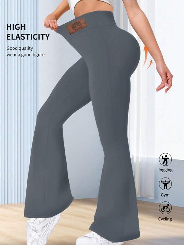 1 pieza Pantalones de cintura alta y ajustada de alta calidad para mujer, mallas acampanadas con control de abdomen minimalistas, pantalones de yoga de unicolor y patas anchas, pantalones deportivos sueltos y elásticos con cintura elástica y etiqueta con diseño, que levantan las caderas y estilizan la cintura