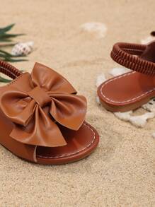 1 Pair Brown Toddler Girls' Flat Sandals, Solid Color PU, Bow Decor Elastic Backstrap, Open Toe, Roman Style Casual Beach Sandals Suitable For 3-15 Years Old Girls, Summer New Arrival