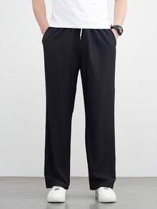 زوج من البناطيل السوداء الرجالية الفضفاضة ذات الساق المستقيمة والواسعة، كاجوال ومتعددة الاستخدامات، قابلة للغسل بالغسالة، بتصميم خصر ربطة