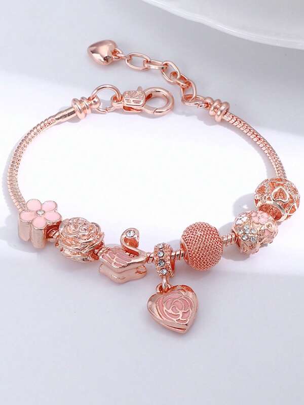 Un brazalete de mujer lujoso con colgante de cisne retro y elegante con efecto de goteo de aceite, corazón con diamantes y bola de rosa con cuentas