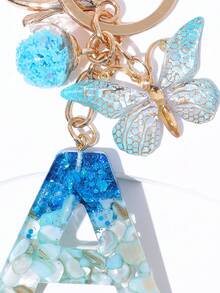 1 szt. Kreatywny, ręcznie robiony motyl, ozdobny brelok z literą z kryształową szklaną kulką w kształcie gwiazdy, zawieszki do torebki i portfela, torba z ozdobnym brelokiem z literą, brelok do kluczyków samochodowych dla kobiet, brelok zapobiegający zgubieniu, prezent na powrót do szkoły dla uczniów, nauczycieli, kolegów z klasy - Niebieski i biały - Zobacz 2