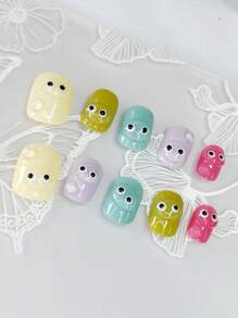 1 set de 10 ongles courts carrés exquis avec un motif peint à la main "Y2K candy dopamine" en trois dimensions et en couleurs transparentes avec de mignons petits yeux, dans un style minimaliste. Ces accessoires pour ongles allongent l'apparence des doigts et apportent une touche .