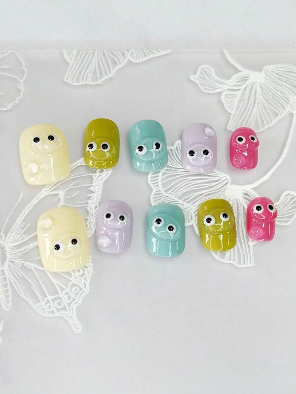 1 set de 10 ongles courts carrés exquis avec un motif peint à la main "Y2K candy dopamine" en trois dimensions et en couleurs transparentes avec de mignons petits yeux, dans un style minimaliste. Ces accessoires pour ongles allongent l'apparence des doigts et apportent une touche .