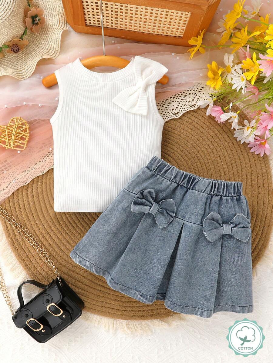 Set de 2 piezas de conjunto elegante y de moda para niñas, suave, transpirable y cómodo, con decoración de moño en chaleco de color liso y falda vaquera azul marino, apropiado para vacaciones, fiestas, uso casual y diario