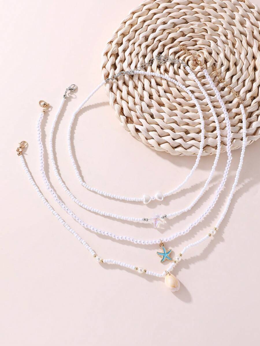 Set de 4 collares con cuentas de perlas con forma de corazón y estrella de mar para niñas