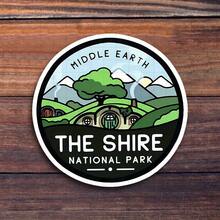 3-Inch "The Shire National Park Sticker, Perfect For Nature Lovers! Use It On Travel Gear, Notebooks, And Home Decor. Great For Hikers, Students, And Fans Of Fantasy Literature. Categories: Nature Stickers, Artistic Style Art, Adventure Stickers, Decorative Designs." - 3inch/7.62cm - View 1