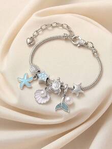 这款时尚独特的纯手工串珠手链饰有水钻、贝壳、海星、仿珍珠、星星、鲸鱼尾巴和海龟吊坠，专为女性设计。它配有可调节可拆卸的铜链，非常适合海滩度假、派对、休闲场合和日常佩戴。它也是一份绝佳的礼物。 - 藍色海洋 - 查看 3