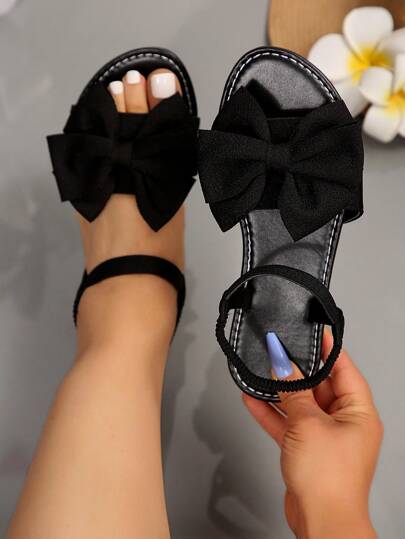 Plus Size & Wide Width Black Sandals, Round Toe Bow Decor Women's Slip-On Slide Sandals, Strap Vacation Style Beach Shoes, Elegant Casual Summer Flat Sandals For Wide Feet