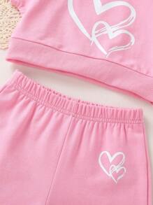 Set de 2 piezas de ropa informal y elegante para niñas, compuesto por sudadera de cuello redondo con gráfico de corazón y manga raglán de manga corta, y pantalones cortos, todo suave, transpirable y cómodo, adecuado para uso diario y vacaciones