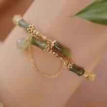 1 élégant bracelet fait main en perles de bambou vertes, convient pour les femmes. Accessoires uniques en forme de feuille avec pompons et fleurs, décoration dorée. Convient pour les soirées et le port casual