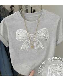 Camiseta básica para mujer de manga corta y cuello redondo con impresión de imitación de lentejuela con grafico de moño. - Gris - Ver 1
