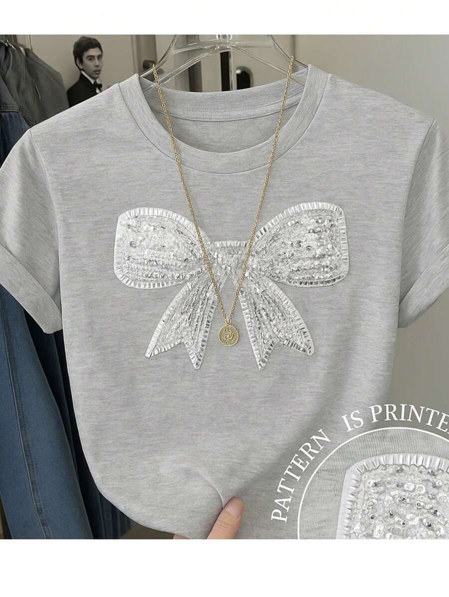 Camiseta básica para mujer de manga corta y cuello redondo con impresión de imitación de lentejuela con grafico de moño. - Gris - Ver 1