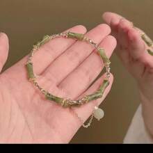 1 élégant bracelet fait main en perles de bambou vertes, convient pour les femmes. Accessoires uniques en forme de feuille avec pompons et fleurs, décoration dorée. Convient pour les soirées et le port casual
