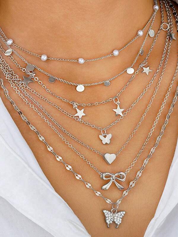 Set de 7 collares con colgantes de corazón, mariposa, estrella y lazo - Conjunto de accesorios diarios, ideal como regalo de vacaciones o para citas para mujer